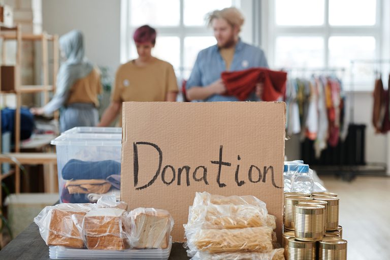 Volunteers organizing food and clothing donations at a community relief center